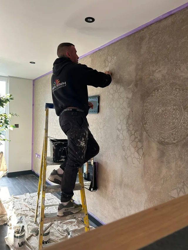 Professional decorator working at height